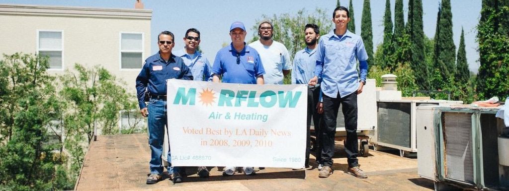 Morflow team holding a sign